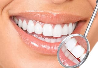 Woman Smiling Reflection Dental Mirror - Trade Winds Dental