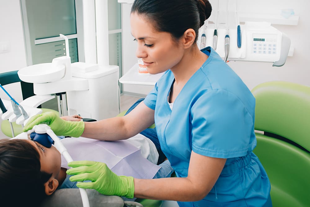 Dentist Administering Sedation Via The Nose - Trade Winds Dental