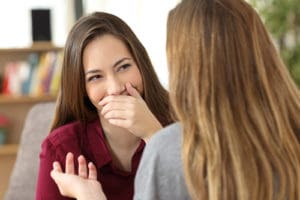 woman hiding her smile