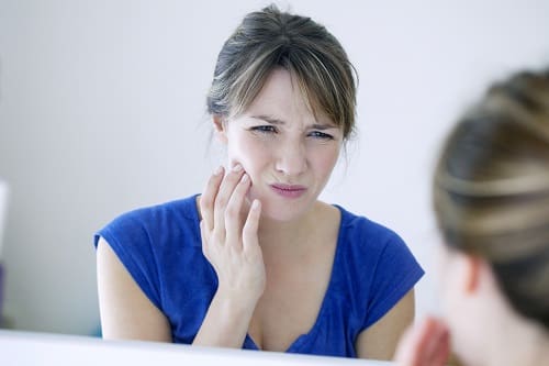 Woman With Toothache - Trade Winds Dental