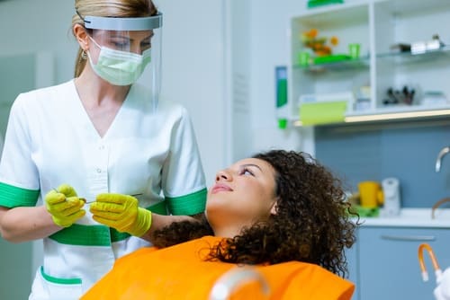 Dentist With Patient In Chair - Trade Winds Dental