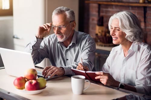 Older Couple Researching On Computer - Trade Winds Dental