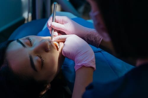 Dentist Performing Procedure - Trade Winds Dental