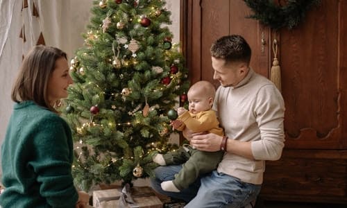 Family Decorates Christmas Tree - Trade Winds Dental
