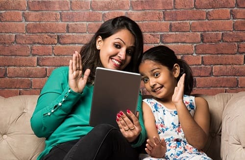 Woman And Young Girl Using Tablet - Trade Winds Dental