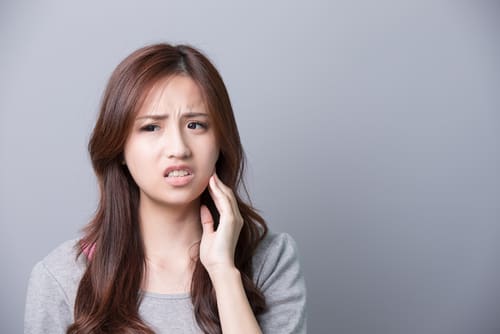 Woman With Sensitive Teeth - Trade Winds Dental