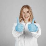 Girl In Lab Coat Giving Two Thumbs Up - Trade Winds Dental
