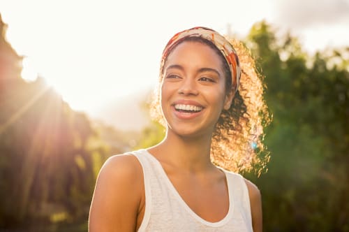 Woman smiling after holistic dentist appointment - Trade Winds Dental