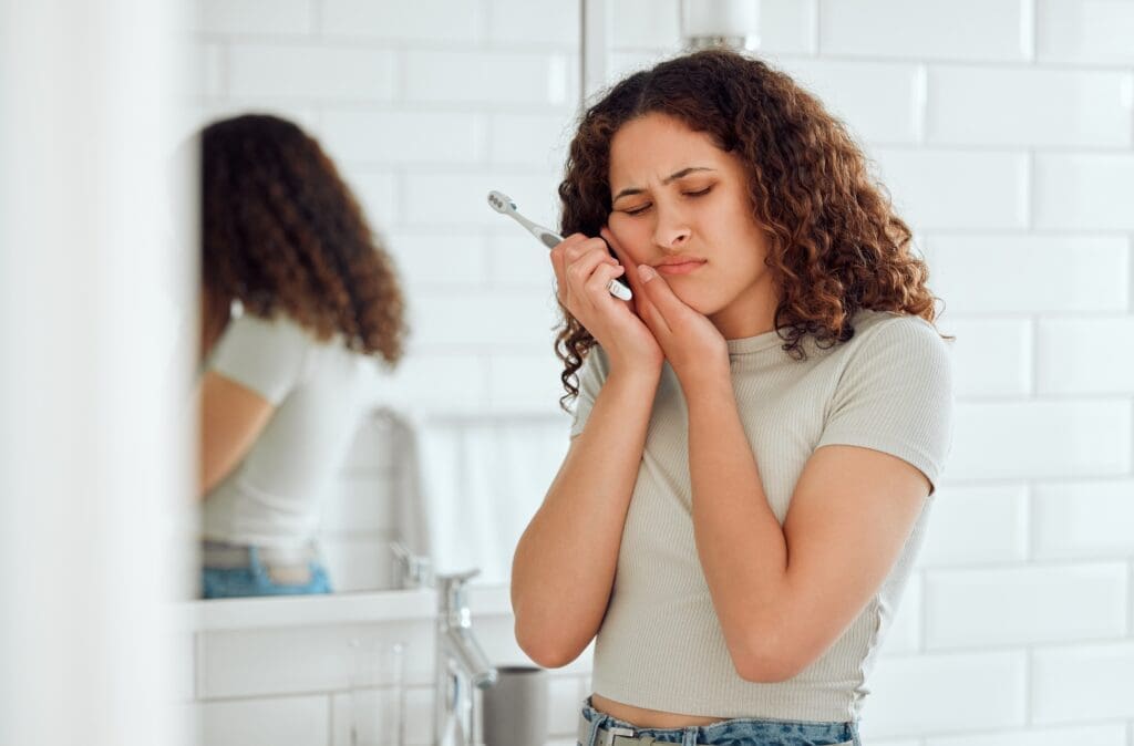 Woman In Pain Having Dental Emergency - Trade Winds Dental