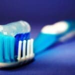 Toothbrush With Toothpaste on Bristles - Trade Winds Dental