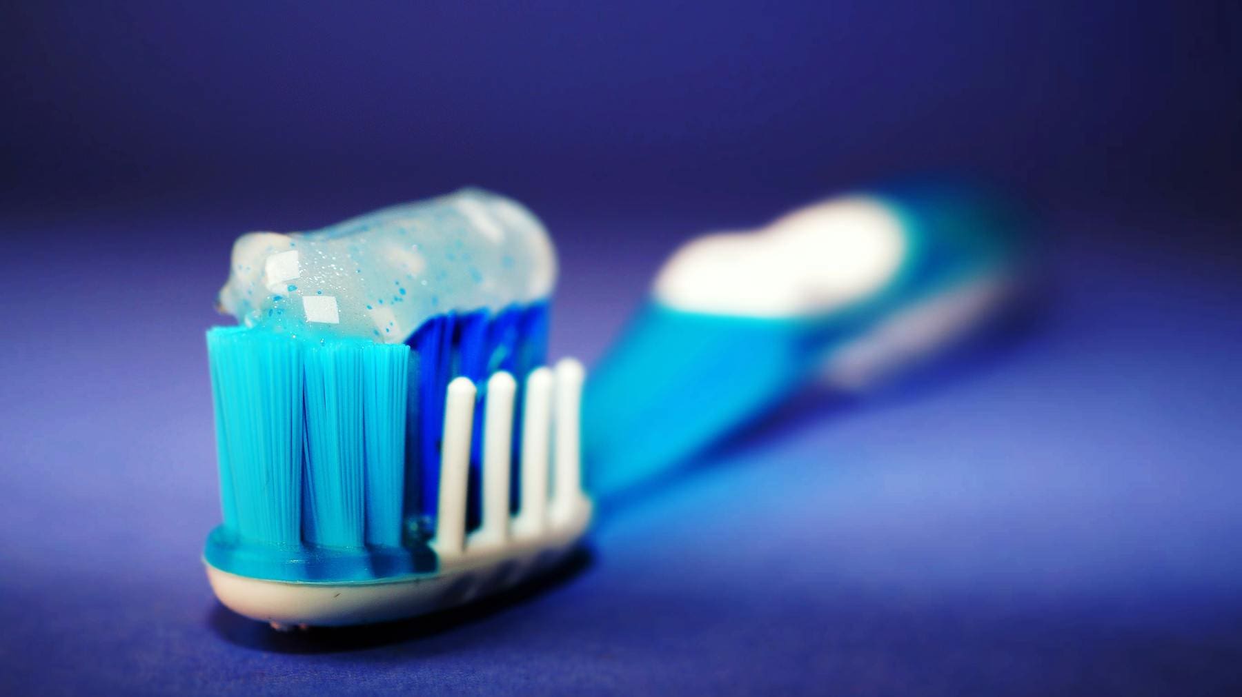 Toothbrush With Toothpaste on Bristles - Trade Winds Dental
