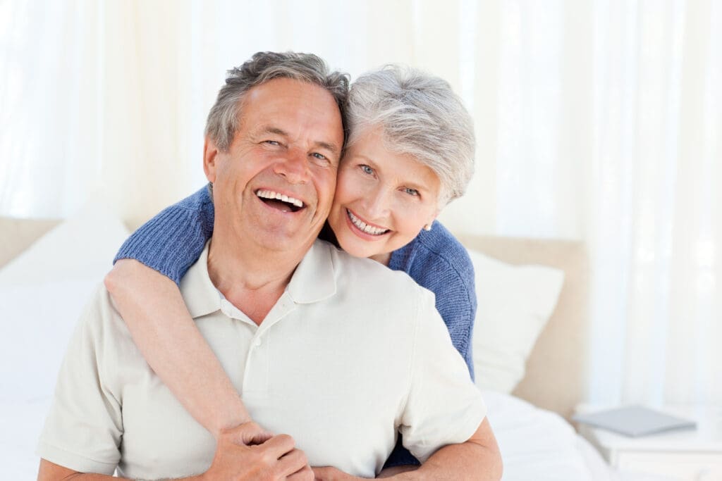 Senior Couple Smiling with Dentures - Trade Winds Dental