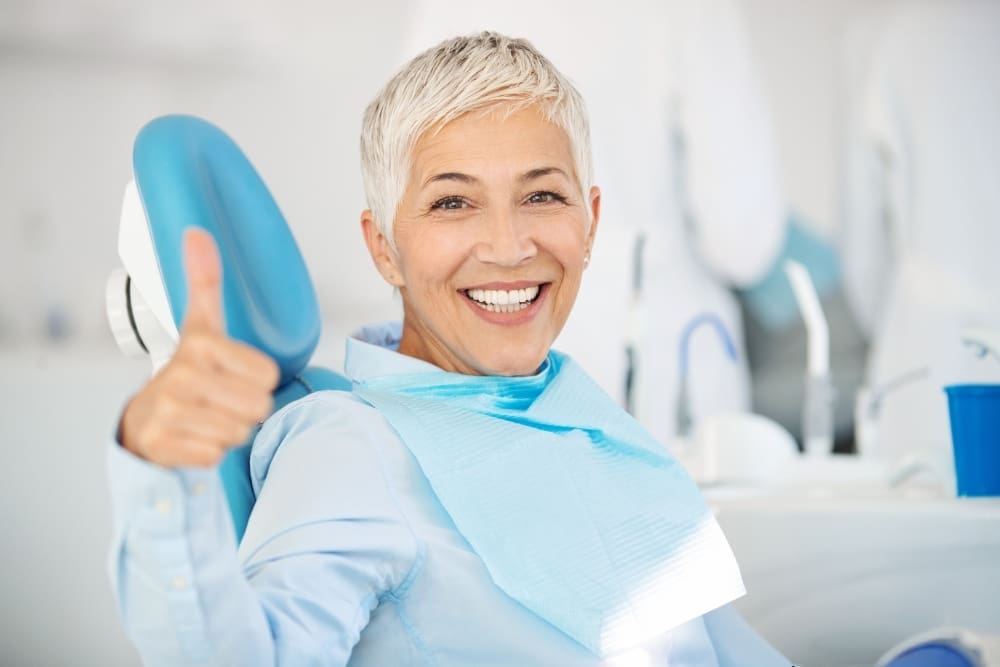 smiling Dental Patient Giving Thumbs Up After Dental Cleaning in Georgetown, TX - Trade Winds Dental