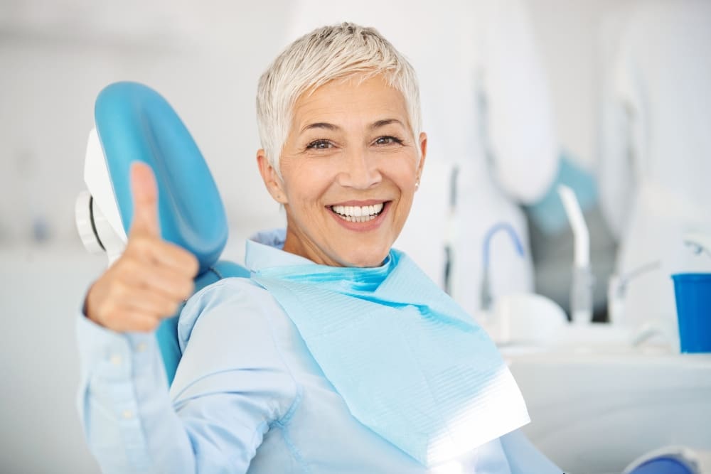smiling Dental Patient Giving Thumbs Up After Dental Cleaning in Georgetown, TX - Trade Winds Dental